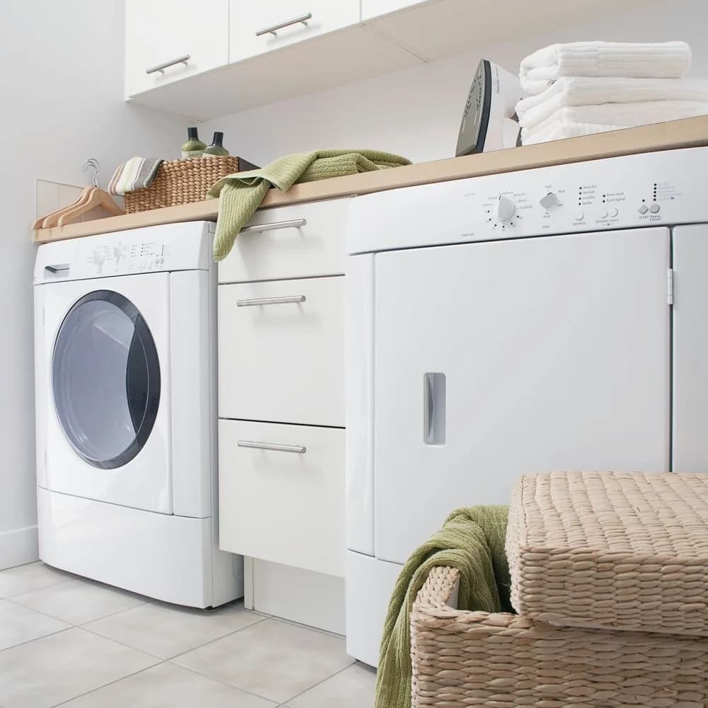 A tidy white laundry with folded towels